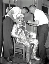 (1960) John H. Glenn Jr., one of the seven recently selected Mercury astronauts, participates in a suit-fitting session.
