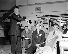 (January 1961) Astronaut John Glenn and news media representatives are pictured during a press conference and spacecraft familiarization tour of Cape Canaveral, Florida.