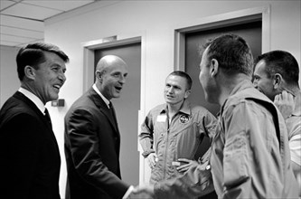 (19 Dec. 1965) This happy round of handshakes took place in the Manned Spacecraft Operations Building crew quarters, Merritt Island, as the Gemini-6 crew (left) welcomed the Gemini-7 crew back to the ...