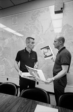 (2 June 1966) Astronauts Thomas P. Stafford (right) and Eugene A. Cernan look over pictures of the lunar surface taken by Surveyor I.