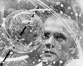 (1961) Astronaut John H. Glenn Jr. looks into a Celestial Training Device (globe) during training in the Aeromedical Laboratory at Cape Canaveral