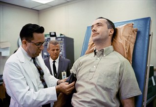 (1 June 1965) Dr. Charles A. Berry, chief of Center Medical Programs, MSC, Houston, Texas, prepares to check the blood pressure of astronaut James A. McDivitt, command pilot for the Gemini-Titan 4 spa...