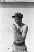A soldier smokes a cigarette; Date November 1946; Location Batavia, Indonesia, Jakarta, Dutch East Indies