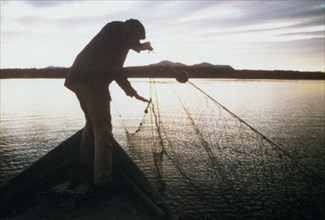 Fishing for whitefish along Kobuk River near the village of Ambler ca. 1973-1975