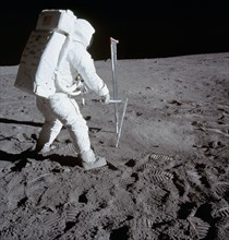 (20 July 1969) Astronaut Edwin E. Aldrin Jr., lunar module pilot, is photographed during the Apollo 11 extravehicular activity (EVA) on the moon. He is driving one of two core tubes into the lunar soi...
