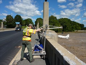 USGS worker collects a Hurricane Irene sample at the Mohawk River at Cohoes on August 29, 2010