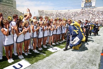2006 - Brigham Young University cheerleaders greet members of the U.S. Navy Parachute Demonstration Team "Leap Frogs" after they parachuted into the Lavell Edwards Stadium, Provo, Utah, prior to a foo...