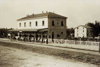 People wiating on a train at Cividale train station in Mirandola Italy ca. 1930