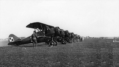 PWS-26 aircraft in CWOL. Commander of the Aviation Officers Training Center in Deblin Lt. Col. Stefan Sznuk (in the distance) releases the first PWS 26 aircraft ca. May 1937