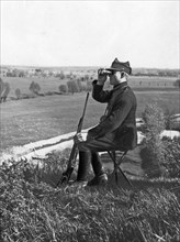 A customs guard officer observes the area through binoculars ca. 1923-1928