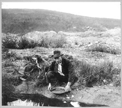 Miner panning gold 1916