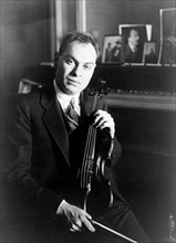 Eddy Brown, half-length portrait, seated, holding his violin 1920-1930 (American Violinist)
