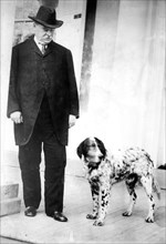 G. Cleveland, standing with dog 1905