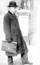 George B. Cortelyou carrying briefcase