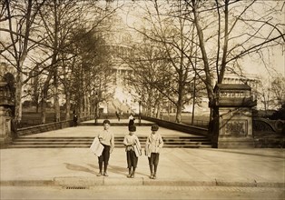 Photograph of a group of news-boys selling on the Capitol steps. Dan Mercurio, a 9 year old chronic truent, began selling when he was 7, April 1912