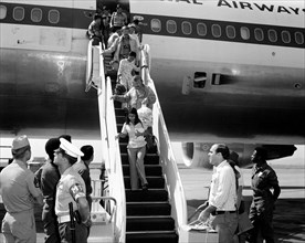 1975 - Vietnamese refugees arrive at the air station after being evacuated from Saigon.