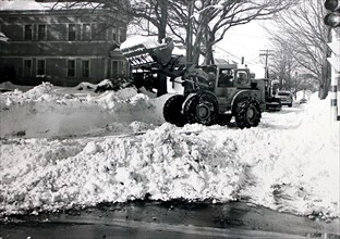 This photograph depicts snow removal crews at work in the aftermath of the 1978 blizzard that struck the northeastern United States.