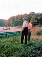 Monza, Autodromo Nazionale, 1962. Enzo Ferrari, founder of the Scuderia Ferrari, along the circuit while observing one of his cars during testing ca. 1962