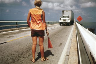 Female Road Worker Directs Traffic During Repairs on the Overseas Highway Leading to Key West ca. 1975