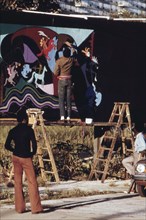 1973 - Artist Ron Blackburn Painting An Outdoor Wall Mural At The Corner Of 33rd And Giles Street In Chicago, 06/1973