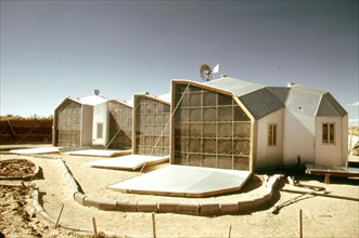 Exterior picture of the south facing walls of a modular solar-heated home near Corrales, New Mexico... 04 1974