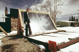 John Keyes, president of International Solarthermics Corporation, shown with the backyard solar heating system he developed... 05 1975