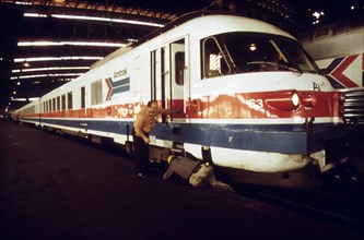 Last minute check of the engine of the Amtrak turboliner passenger train is made before departure from St. Louis, Missouri, to Chicago, Illinois, June 1974