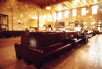 Massive wooden benches, a hallmark in terminals during the heyday of railroading, look at home in the large interior of the union terminal in Portland, Oregon, July 1974