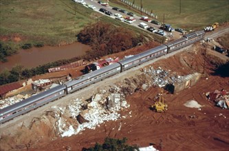 The Lone Star passenger train slowly makes its way past debris which resulted from a freight train derailment in Oklahoma which disrupted rail traffic for two days, June 1974