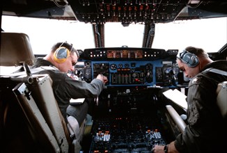1979 - A pilot and copilot operate the new triple inertial navigation system (INS) in the cockpit of a C-5A Galaxy aircraft during the VOLANT GALAXY program.