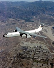 An air-to-air left side view of a C-141 Starlifter aircraft
