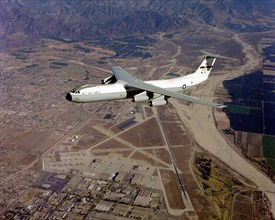 An air-to-air left side view of a C-141 Starlifter aircraft