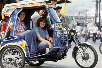 Philippines - Dependent wives of crewmen from the guided missile cruiser USS STERETT (CG-31) ride in a jeepney