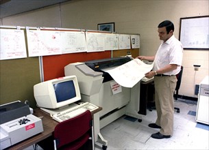 Engineer monitoring a printout