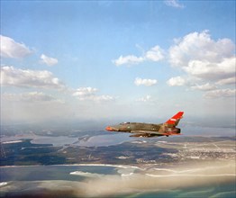 Air-to-air left side view of a QF-100D Super Sabre aircraft.