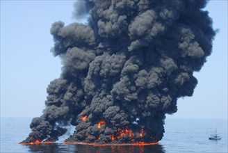 A controlled burn of oil from the Deepwater Horizon/BP oil spill sends towers of fire hundreds of feet into the air over the Gulf of Mexico ca. June 9, 2010
