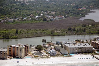Florida's mangrove forests were hard hit by the uncommonly cold temperatures in January, 2010. Here, a dull brown swath of freeze-damaged mangroves cuts across the photograph, Pinellas County, FL -  c...