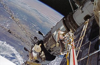 Cosmonaut Vasili V. Tsibliyev, Mir-23 commander, operates at the end of the Russian Mir Space Station&#0146;s STRELA boom during a space walk on April 29, 1997