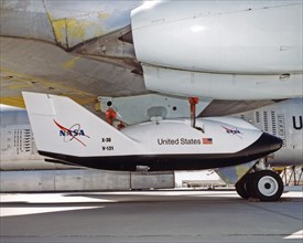 A close-up view of the X-38 research vehicle mounted under the wing of the B-52 mothership prior to a 1997 test flight