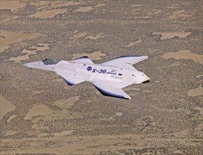 X-36 in Flight over Mojave Desert - The unusual lines of the X-36 technology demonstrator contrast sharply with the desert floor as the remotely piloted aircraft scoots across the California desert at...