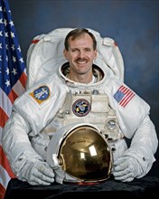 Official portrait of Astronaut Steve Smith wearing an EMU