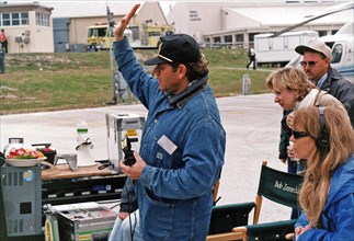 Robert Zemeckis, director/producer, and other Warner Bros. crew members oversee the filming of scenes for the movie "Contact" at Kennedy Space Center's Launch Complex 39 Press Site on January 30 ca. 1...