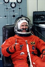 STS-81 Mission Specialist John M. Grunsfeld. gives a thumbs-up as he completes his launch/entry suitup in the Operations and Checkout (O&C) Building ca. 1997