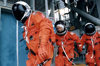 Three members of the STS-83 flight crew head toward the orbiter access arm on the 195-foot level Launch of Pad 39A ca. 1997