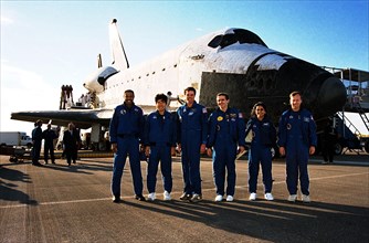 The STS-87 crew pose in front of the orbiter Columbia shortly after landing on Runway 33 at KSC's Shuttle Landing Facility ca. 1997