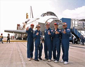STS-84 crew members give a "thumbs up" to press representatives and other onlookers on KSC’s Runway 33 after landing of the successful nine-day mission ca. 1997