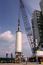 Workers erect the first stage of a Lockheed Martin Launch Vehicle-2 (LMLV-2) at Launch Complex 46 at Cape Canaveral Air Station, Fla ca. 1997