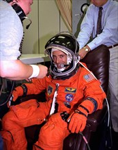 Assisted by suit technicians and others in the Operations and Checkout Building, STS-84 Mission Specialist Jean-Francois Clervoy dons his launch and entry suit during final prelaunch preparations ca. ...