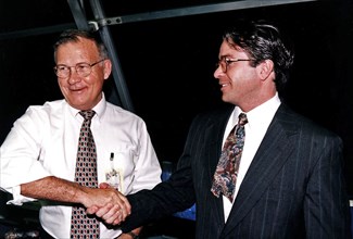 KSC Center Director Jay F. Honeycutt, at left, shakes hands with Scott Cilento, the new flow director of the Space Shuttle orbiter Discovery, in the firing room of the Launch Control Center (LCC) duri...