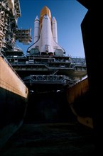 The Space Shuttle Atlantis sits majestically atop its Mobile Launcher Platform and a Crawler-Transporter which straddle the Launch Pad 39A flame trench ca. 1997
